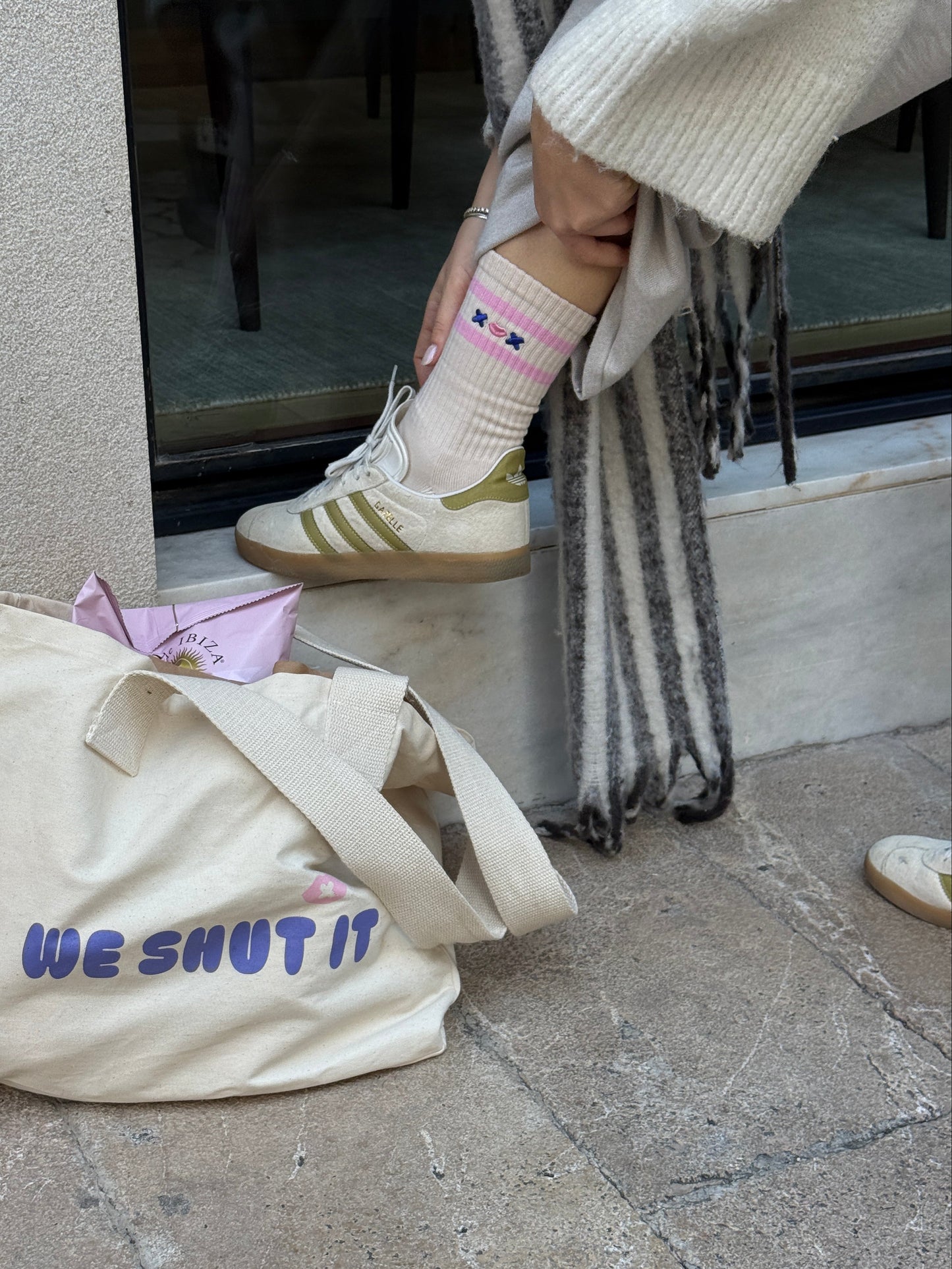 We shut it glow tote bag standing on the floor surrounded by adidas shoes and WSI glow socks
