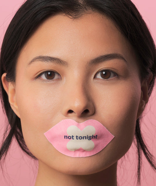 We shut it lip mouth tape on a female model, that says "not tonight"