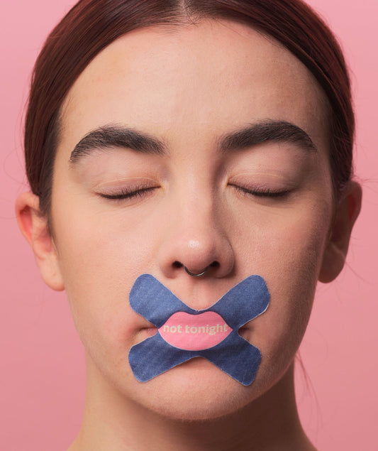 We shut it cross mouth tape on a female model, that says "not tonight"