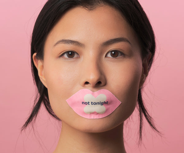 We shut it lip mouth tape on a female model, that says "not tonight"