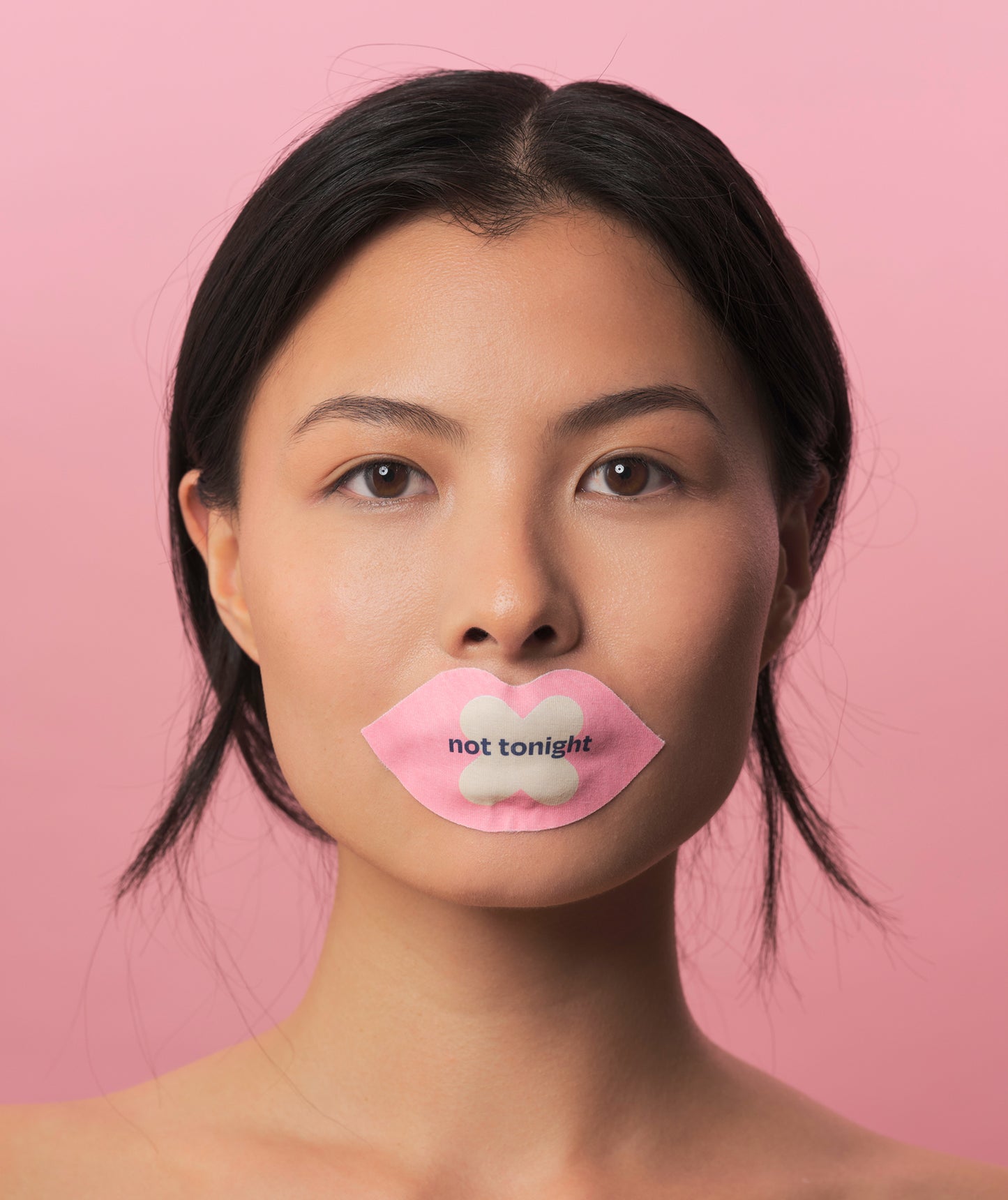 We shut it lip mouth tape on a female model, that says "not tonight"