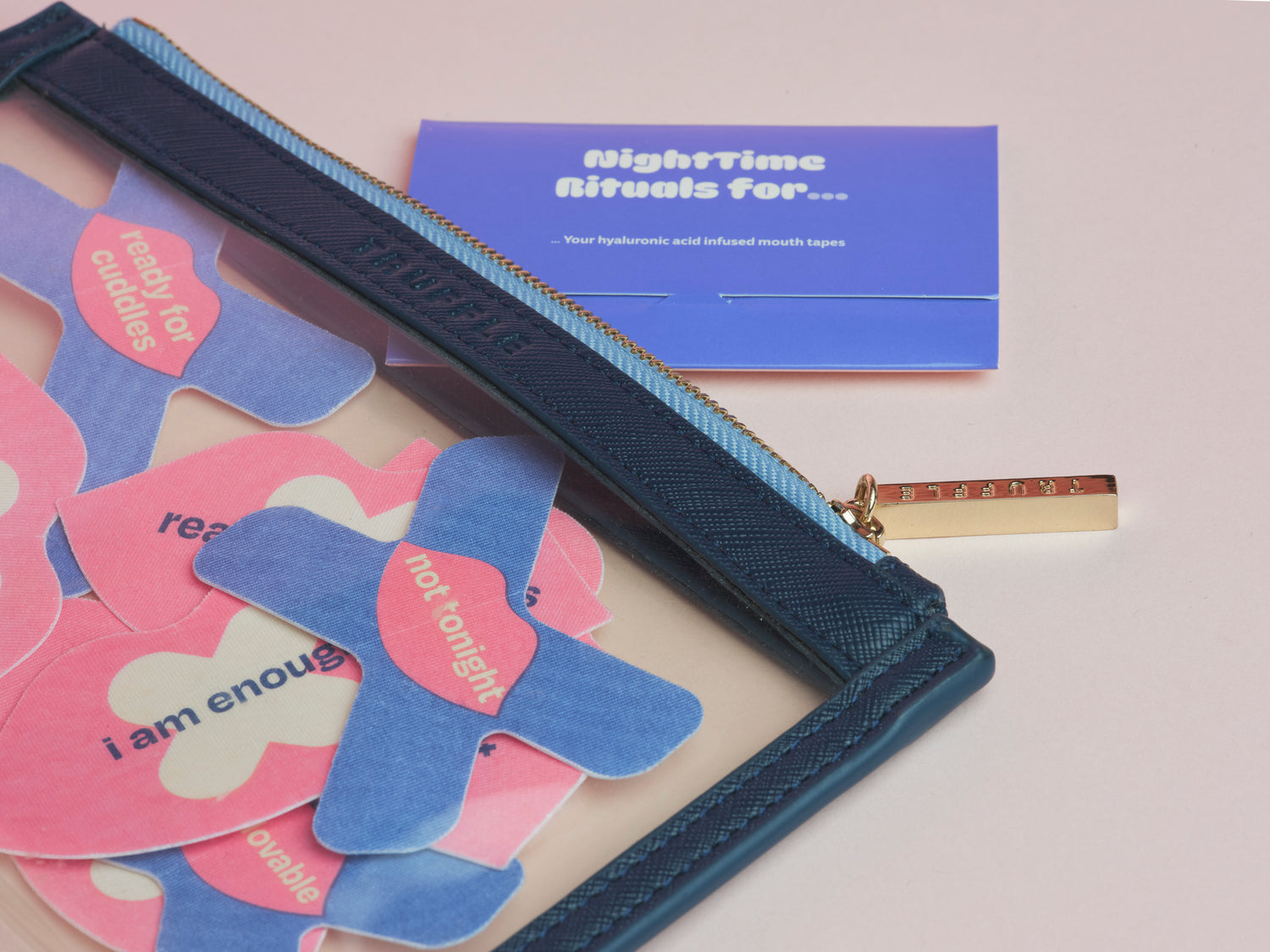 Blue pouch with mouth tapes and a purple card with text on a light pink background