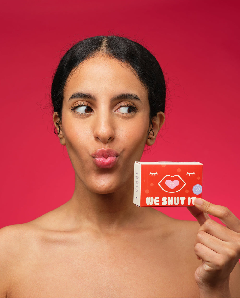 We Shut It mouth tapes for better sleep help by a female model against a red background.