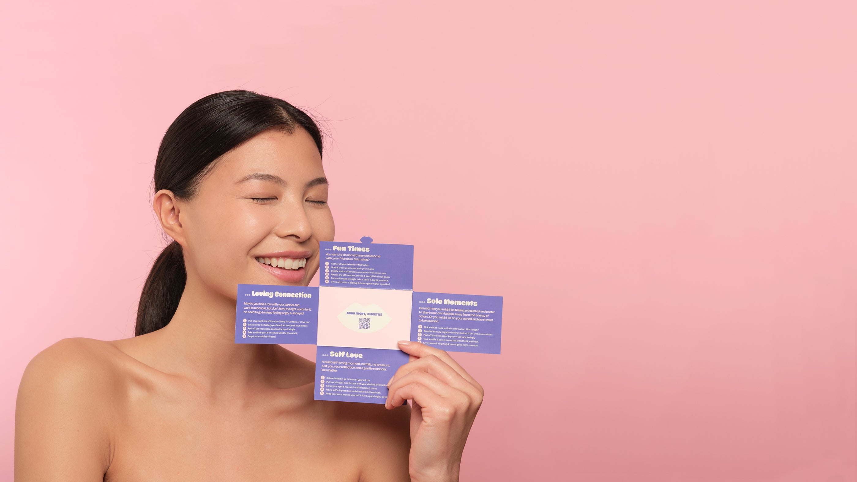We Shut It night time ritual card for wellbeing held by a brunette model against a pink background.